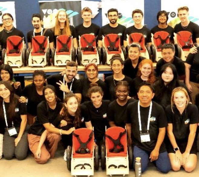 The Tikkun Olam Makers fellowship cohort posed with rows of adaptive wheeled seats
